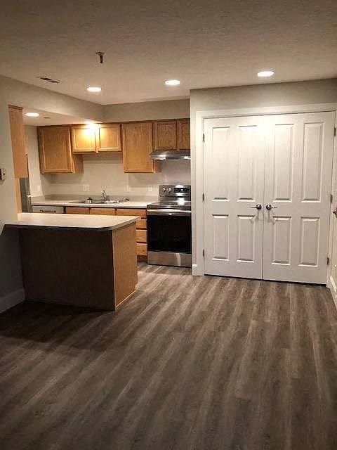 A kitchen with wooden cabinets and a white door.